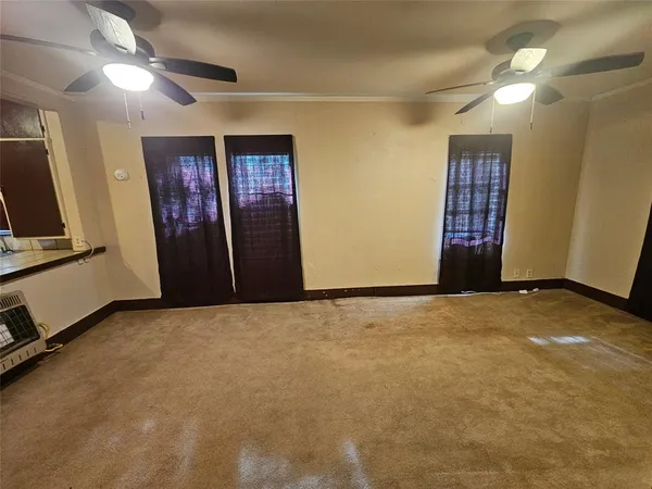 a view of an empty room with a fireplace