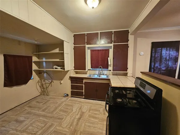 a kitchen with stainless steel appliances granite countertop a sink and a stove