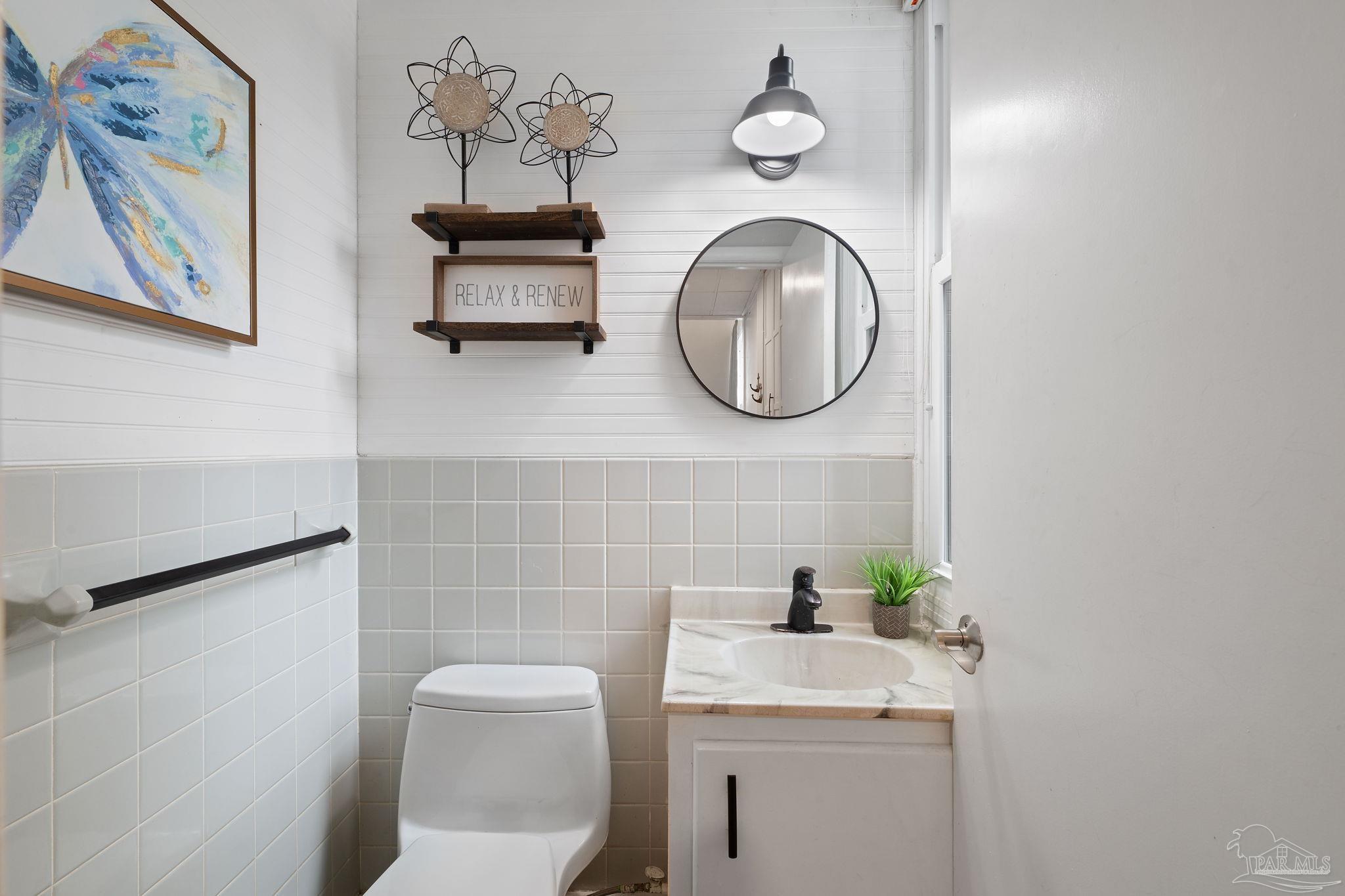 201 Pensacola Beach Road, Unit D24 Gulf Breeze, FL 32561 - Photo 12 of 29 a bathroom with a toilet and a sink