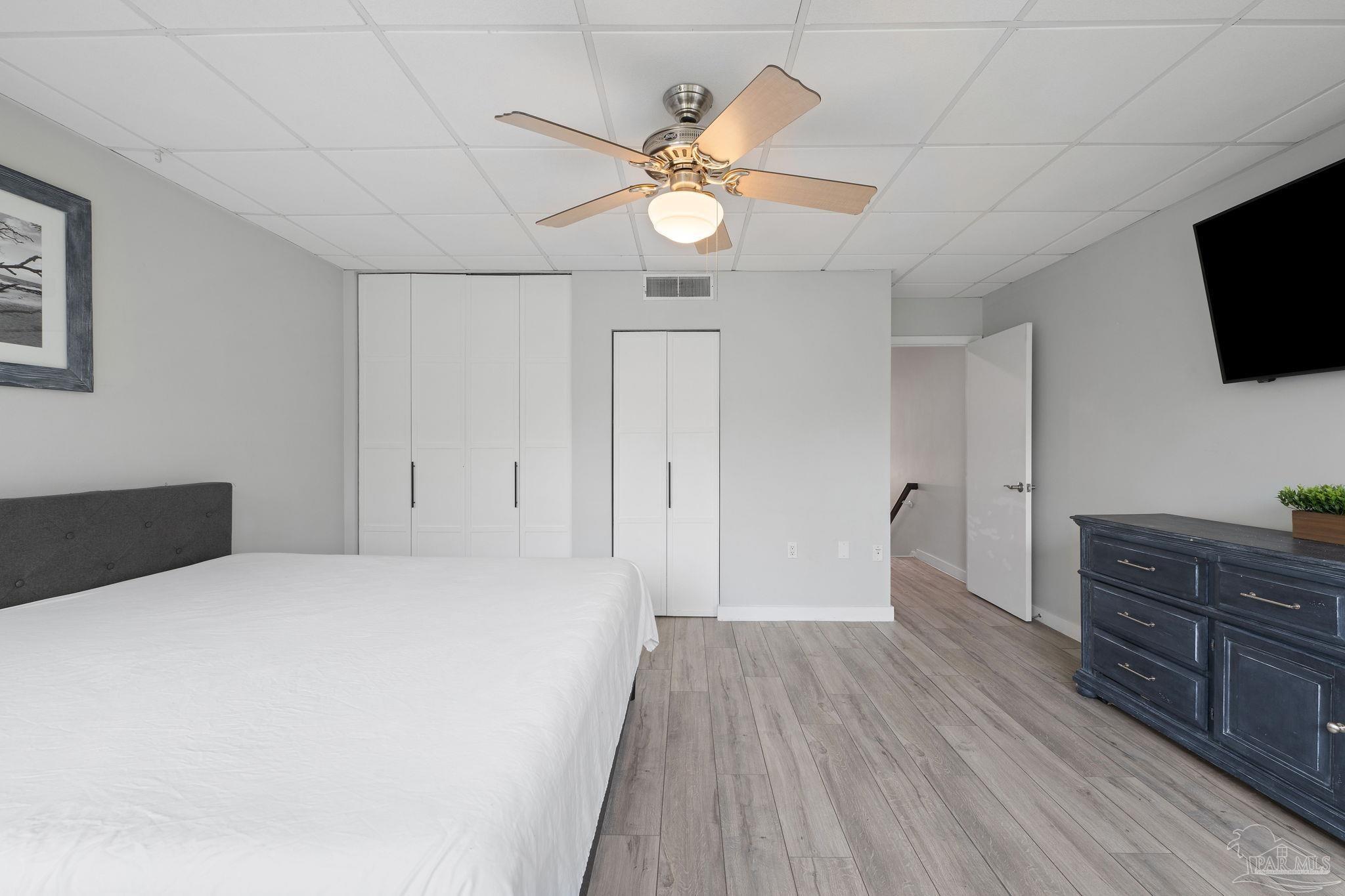 201 Pensacola Beach Road, Unit D24 Gulf Breeze, FL 32561 - Photo 15 of 29 a bedroom with a bed and a flat screen tv