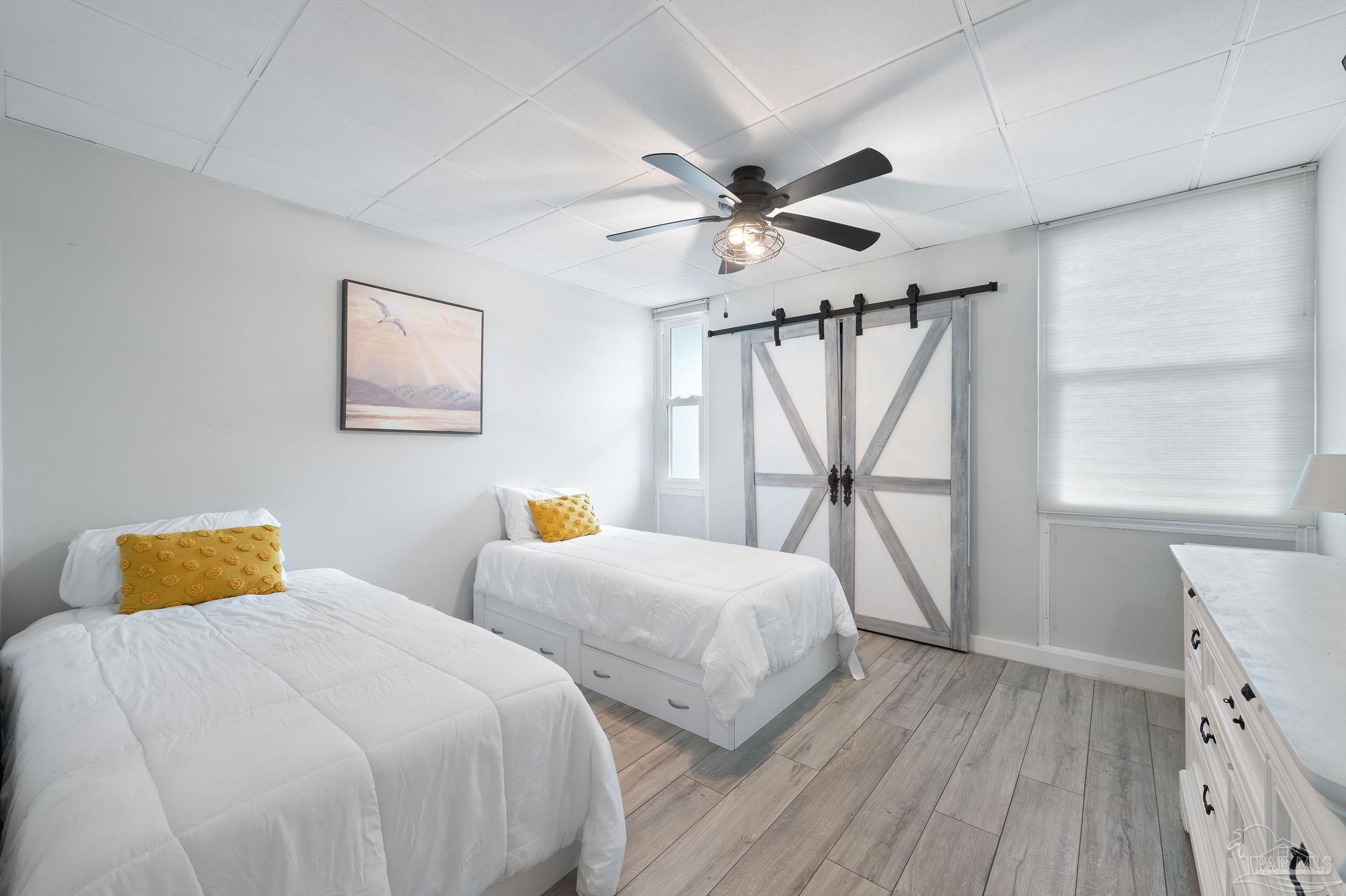 201 Pensacola Beach Road, Unit D24 Gulf Breeze, FL 32561 - Photo 18 of 29 a bedroom with two beds and a window