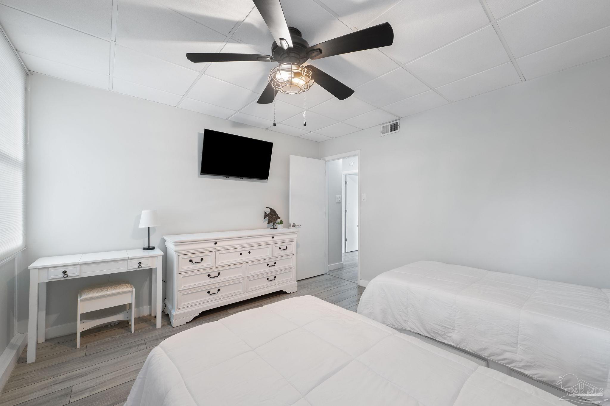 201 Pensacola Beach Road, Unit D24 Gulf Breeze, FL 32561 - Photo 19 of 29 a bedroom with a bed a window and a flat screen tv