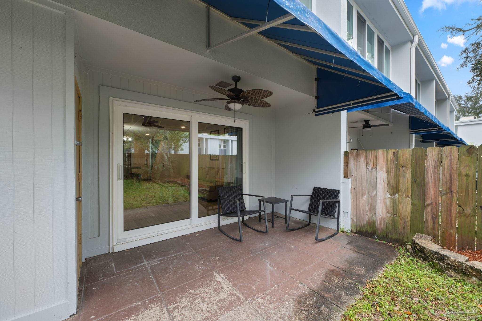 201 Pensacola Beach Road, Unit D24 Gulf Breeze, FL 32561 - Photo 20 of 29 a view of a porch with chairs and floor to ceiling window