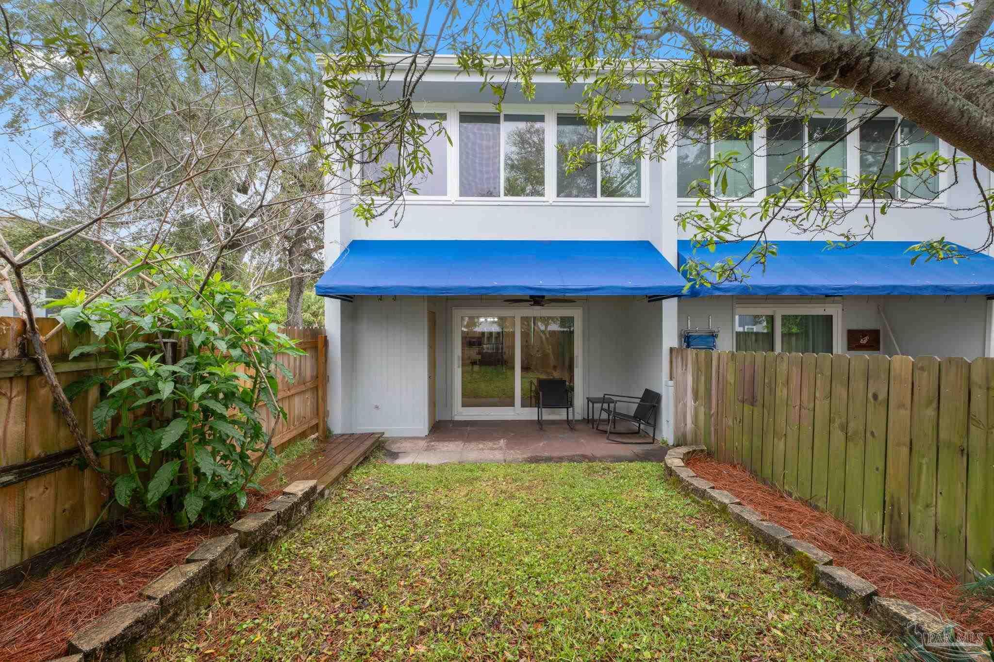 201 Pensacola Beach Road, Unit D24 Gulf Breeze, FL 32561 - Photo 21 of 29 a view of a house with a yard