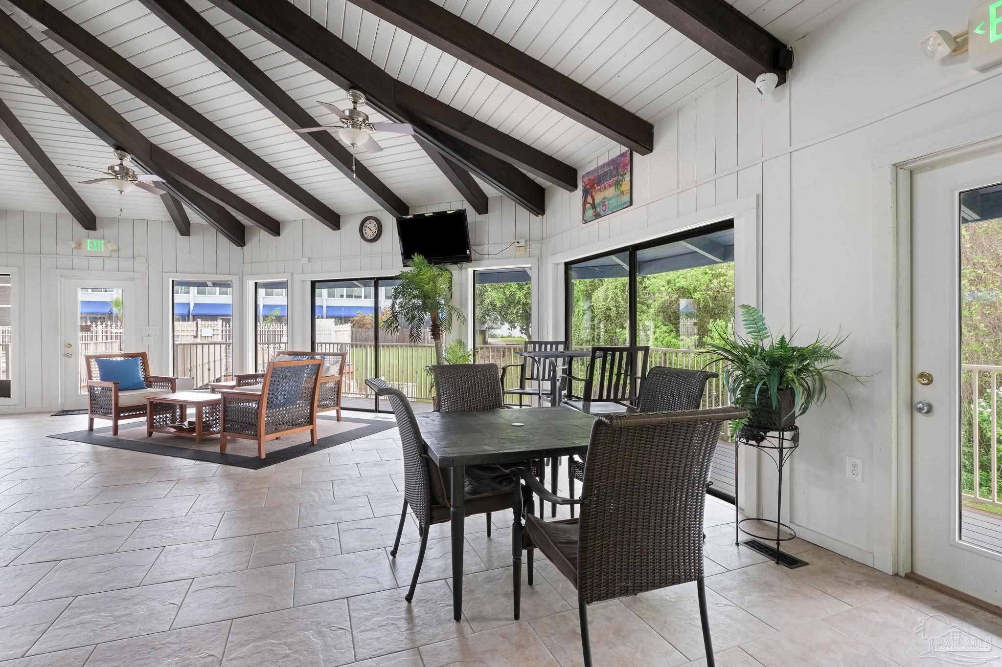 201 Pensacola Beach Road, Unit D24 Gulf Breeze, FL 32561 - Photo 28 of 29 a dining room with furniture water view and a potted plant