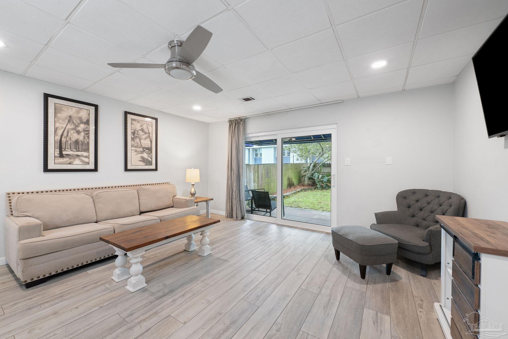 201 Pensacola Beach Road, Unit D24 Gulf Breeze, FL 32561 - Photo 8 of 29 a living room with furniture and a wooden floor