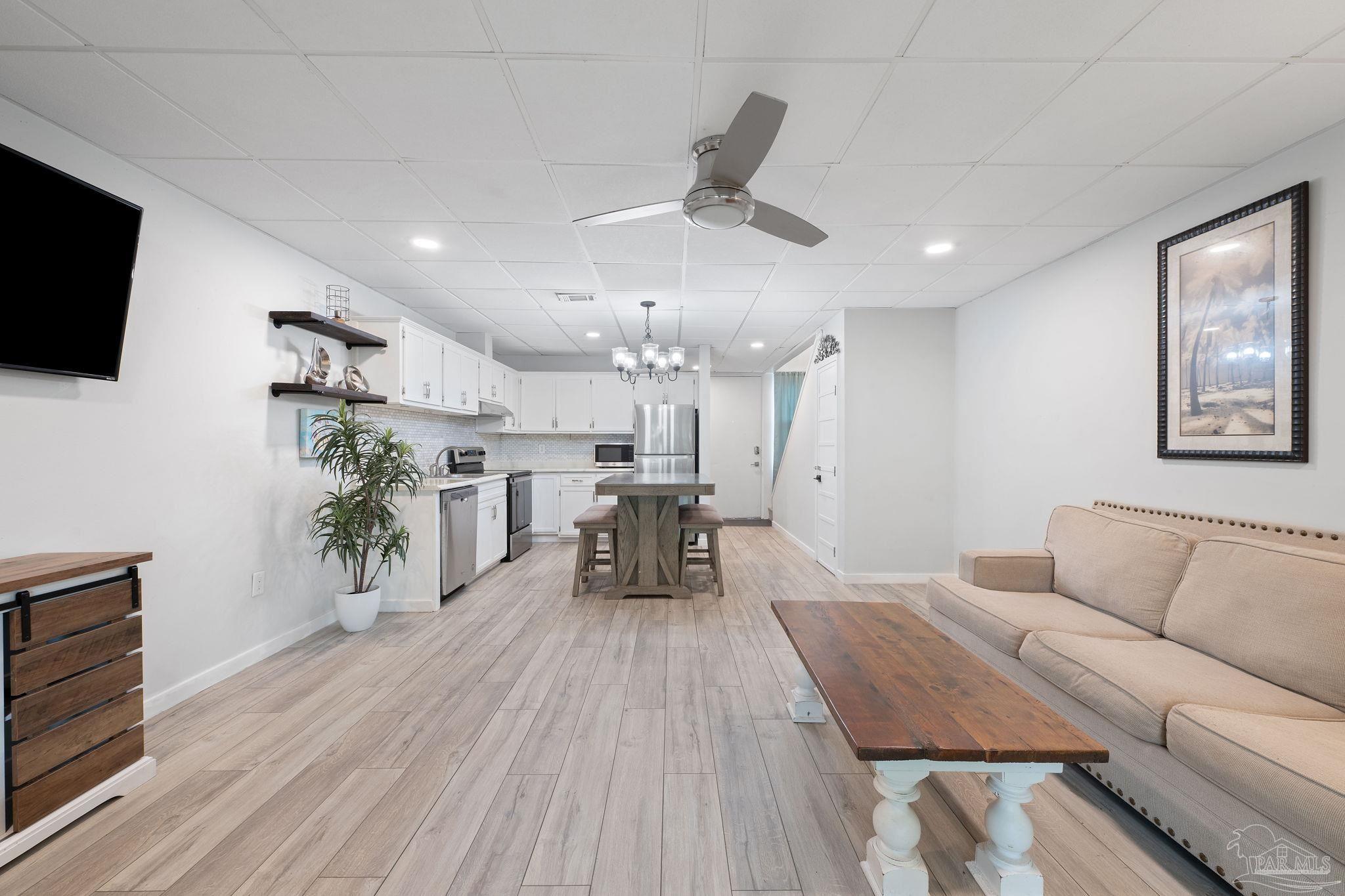 201 Pensacola Beach Road, Unit D24 Gulf Breeze, FL 32561 - Photo 9 of 29 a living room with furniture and a wooden floor