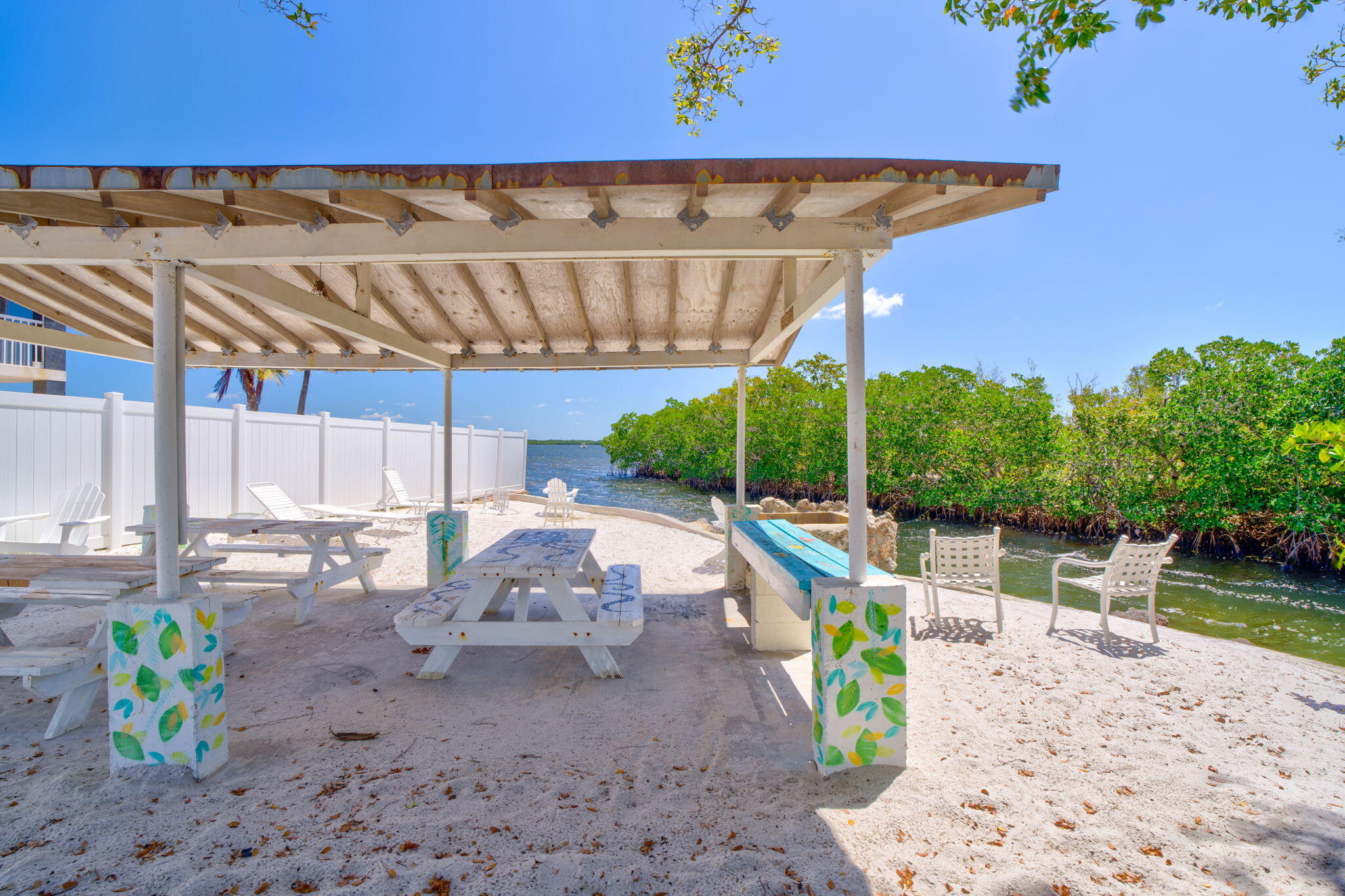 446 Largo Avenue Key Largo, FL 33037 - Photo 15 of 18 a view of a backyard with lawn chairs under an umbrella