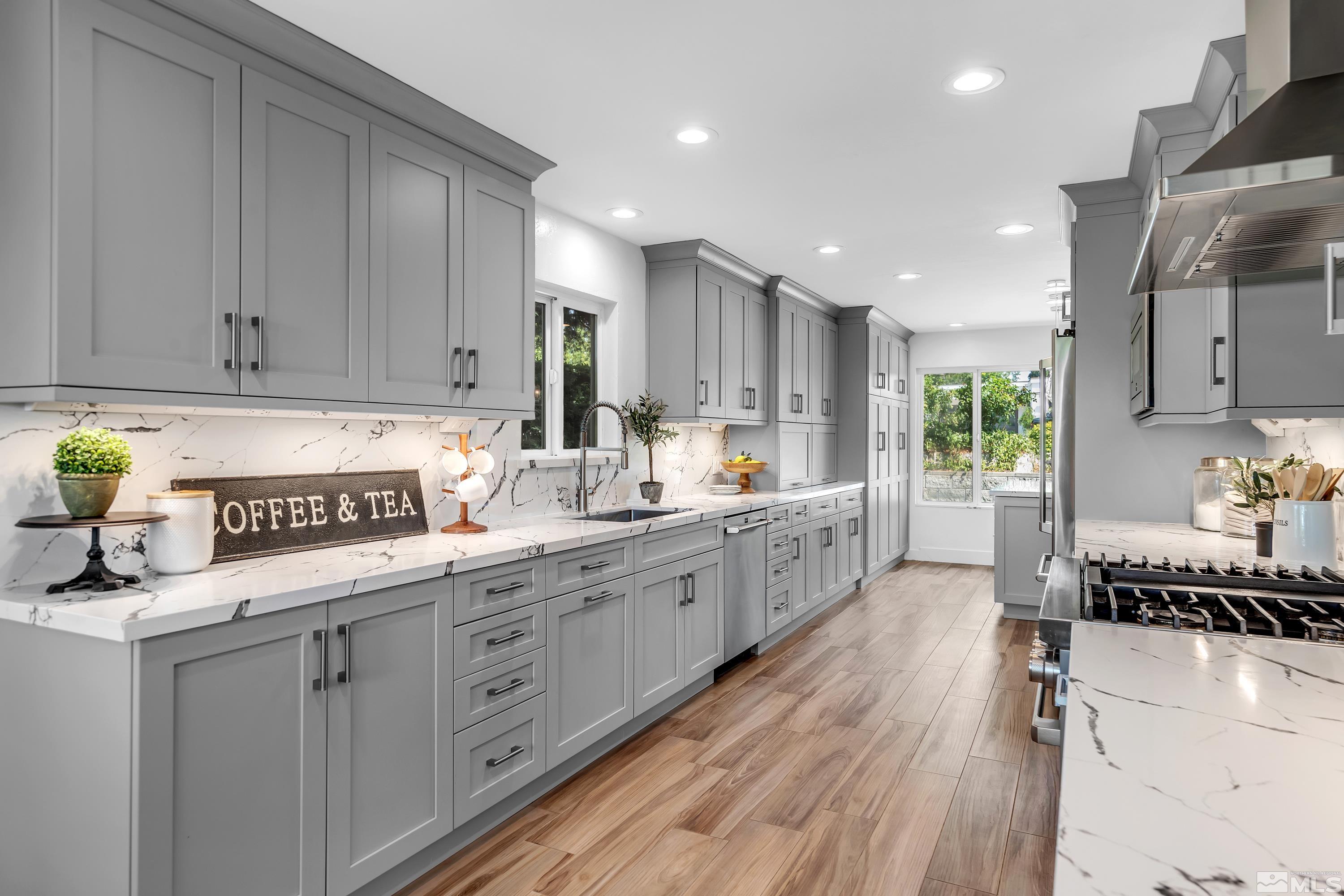 2370 Fireside Circle Reno, NV 89509 - Photo 11 of 29 a kitchen with kitchen island granite countertop a sink window and cabinets