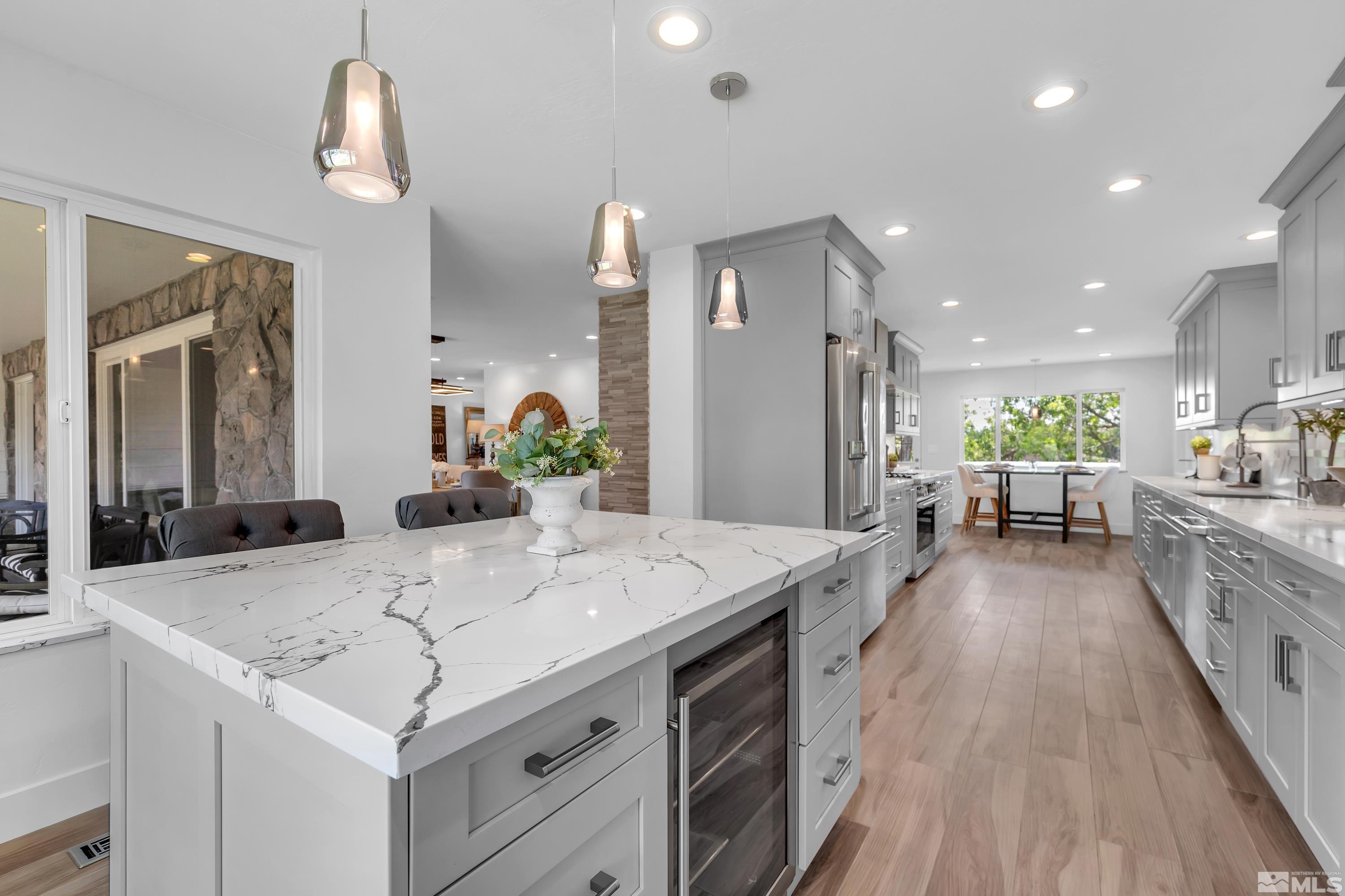2370 Fireside Circle Reno, NV 89509 - Photo 13 of 29 a large kitchen with kitchen island a stove a table a sink and cabinets