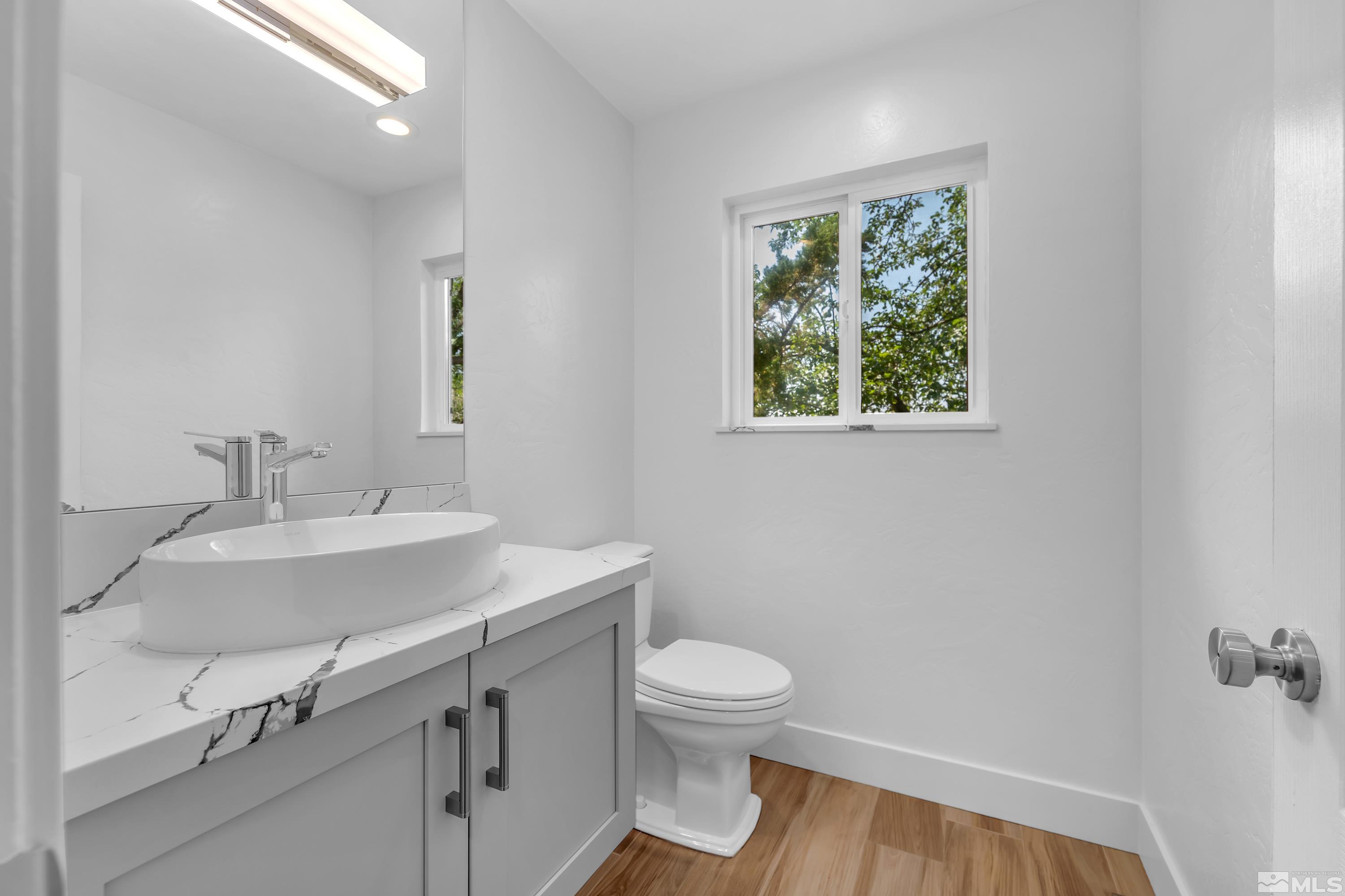 2370 Fireside Circle Reno, NV 89509 - Photo 18 of 29 a bathroom with a sink a toilet and a window