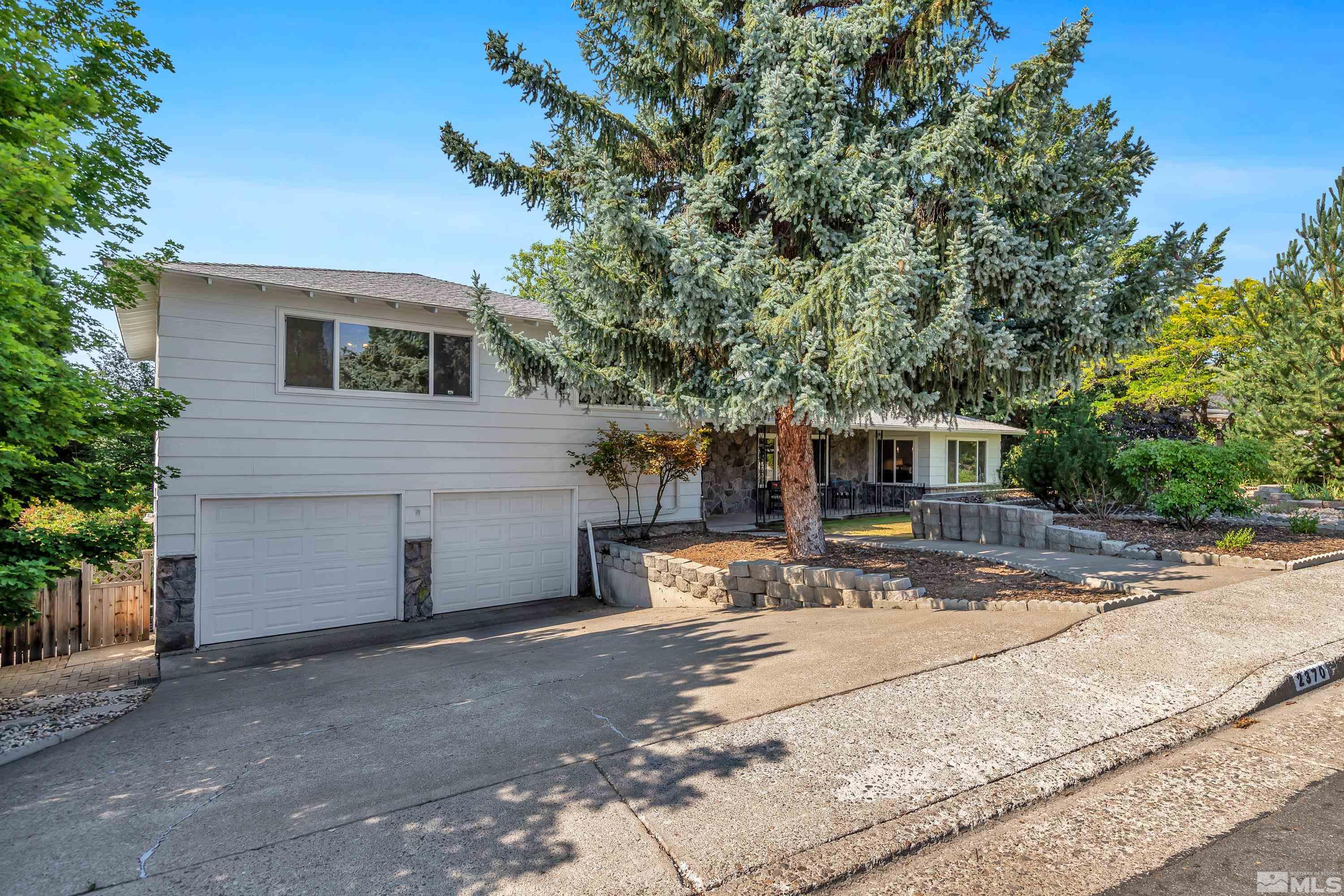 2370 Fireside Circle Reno, NV 89509 - Photo 4 of 29 a front view of a house with a yard