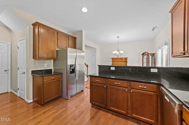 a kitchen with stainless steel appliances a stove microwave and sink