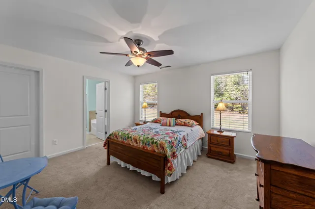 a bedroom that has a bed and a chandelier