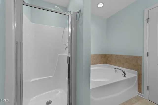 a bedroom with a bed a desk and chair with a window