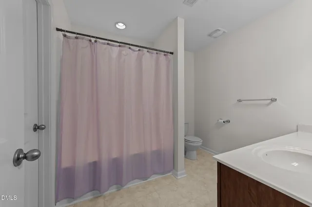 a view of walk in closet with clothes