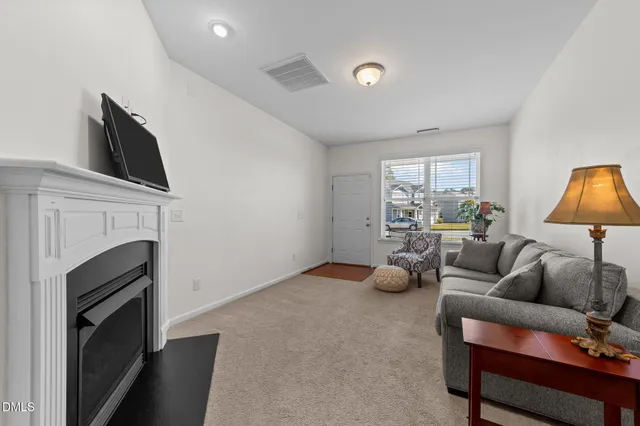 a view of a dining room with furniture a chandelier and wooden floor