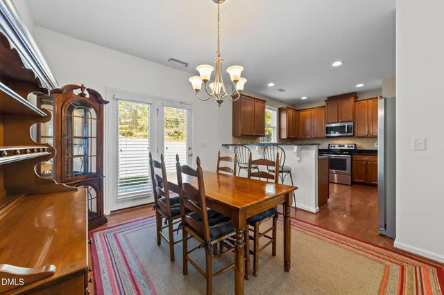 a view of a dining room with furniture and chandelier