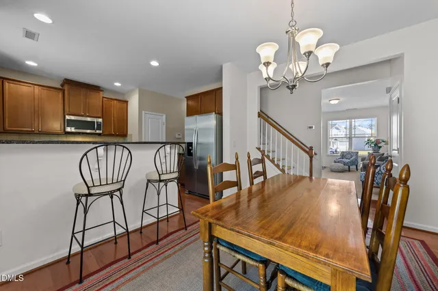 a kitchen with stainless steel appliances granite countertop a stove a sink a microwave a refrigerator and cabinets