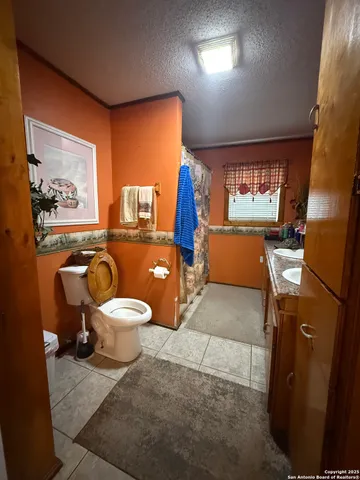 a bathroom with a toilet a sink and a mirror