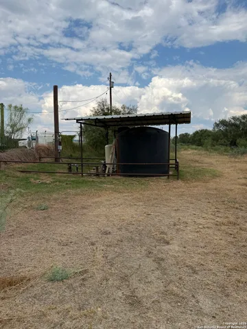 a view of a terrace with a table and chairs