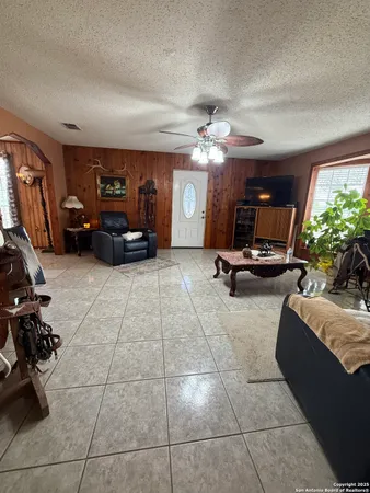 a living room with furniture gym equipment and a large window