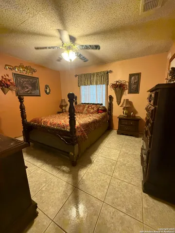 a bedroom with a bed and ceiling fan