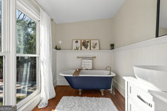 a living room with stainless steel appliances kitchen island granite countertop furniture and a large window
