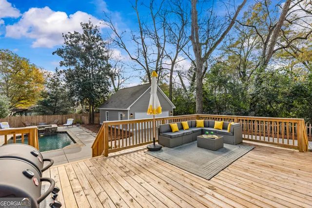 a view of balcony with wooden floor and outdoor seating