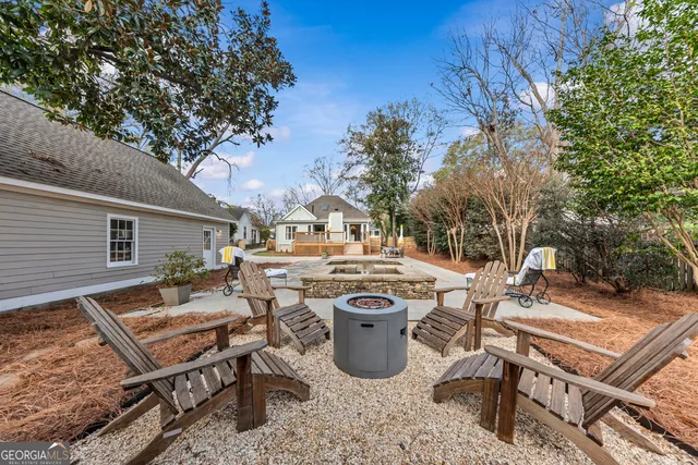 a view of a house with pool and chairs