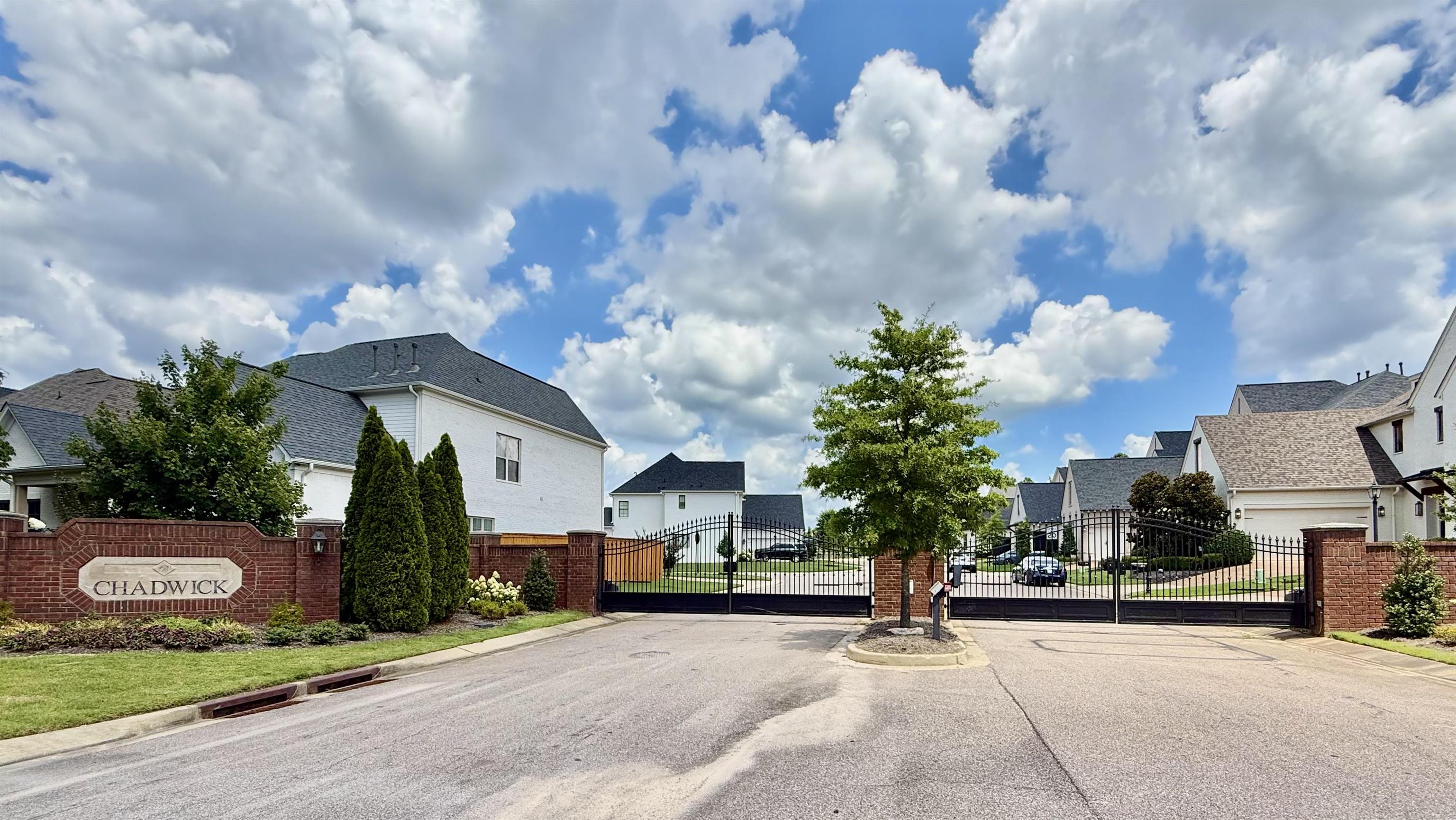 1746 Chadwick Farms Loop North Collierville, TN 38017 - Photo 2 of 35 View of asphalt street featuring a residential view, a gate, a gated entry, and curbs