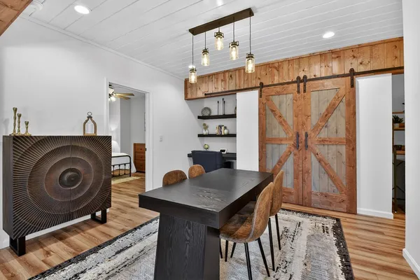 a living room with furniture a fireplace and a table