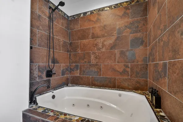 a bathroom with a granite countertop sink mirror vanity and toilet