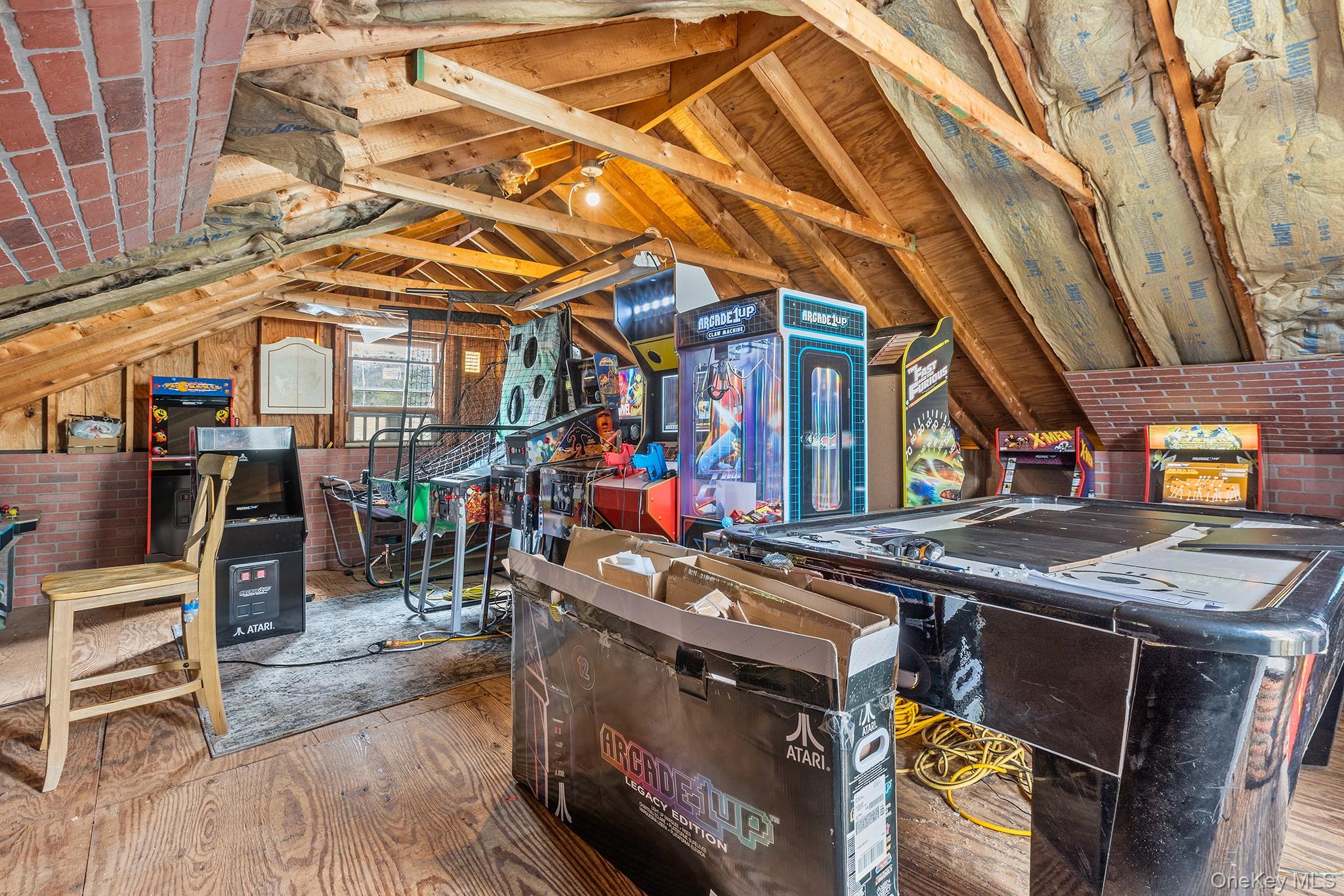 43 Taylor Road Parksville, NY 12768 - Photo 25 of 29 Attic space featuring exposed wood beams, wood-finish flooring, and brick accents