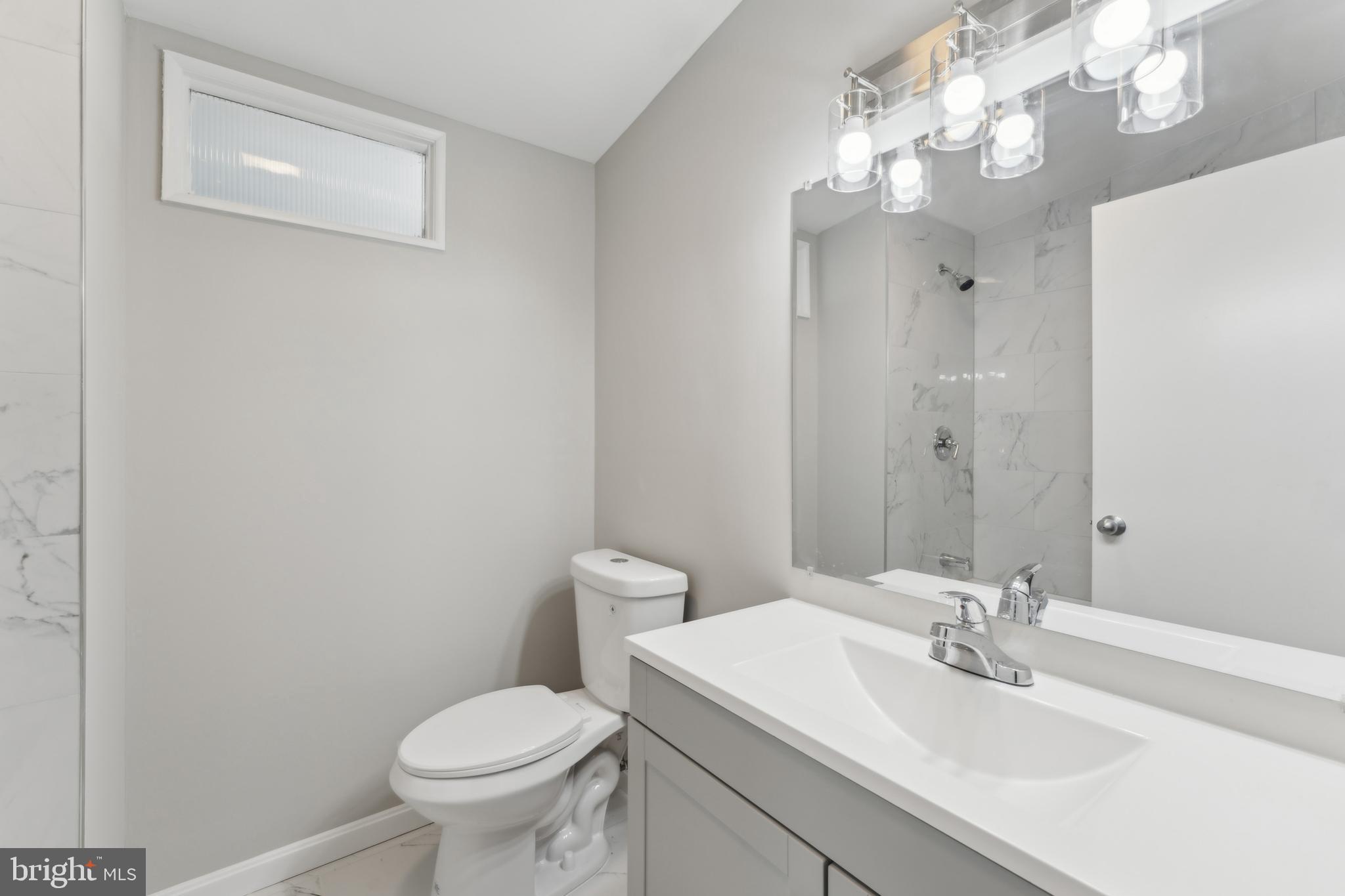 600 Sisson Street Silver Spring, MD 20902 - Photo 14 of 28 a bathroom with a toilet sink and mirror