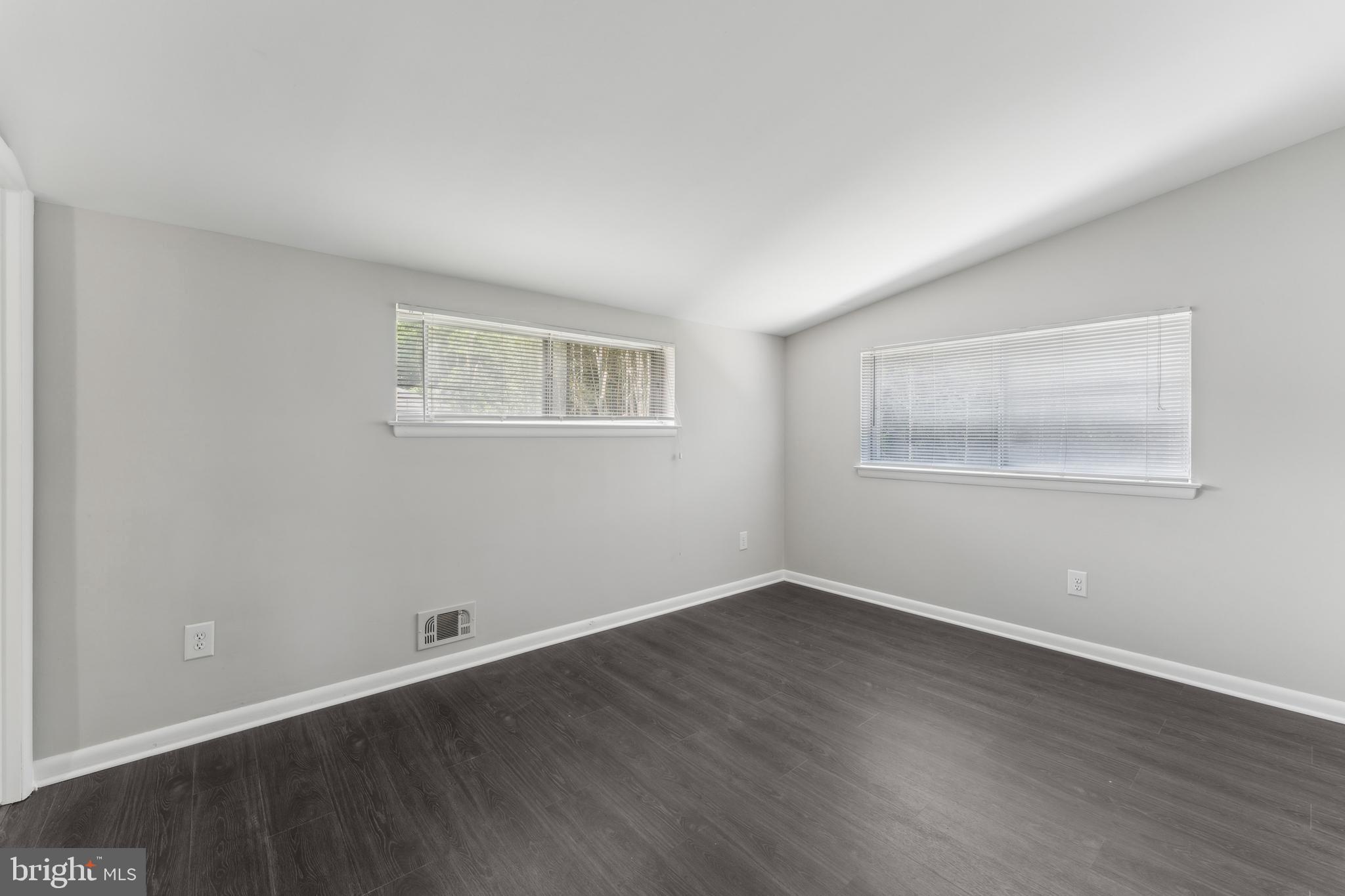 600 Sisson Street Silver Spring, MD 20902 - Photo 15 of 28 a view of an empty room with wooden floor and a window