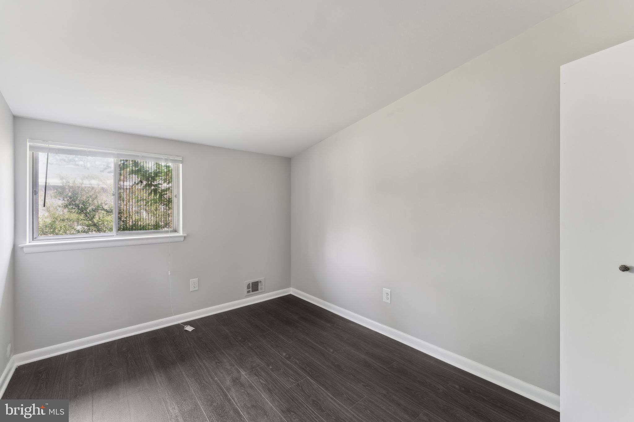 600 Sisson Street Silver Spring, MD 20902 - Photo 20 of 28 an empty room with wooden floor and window