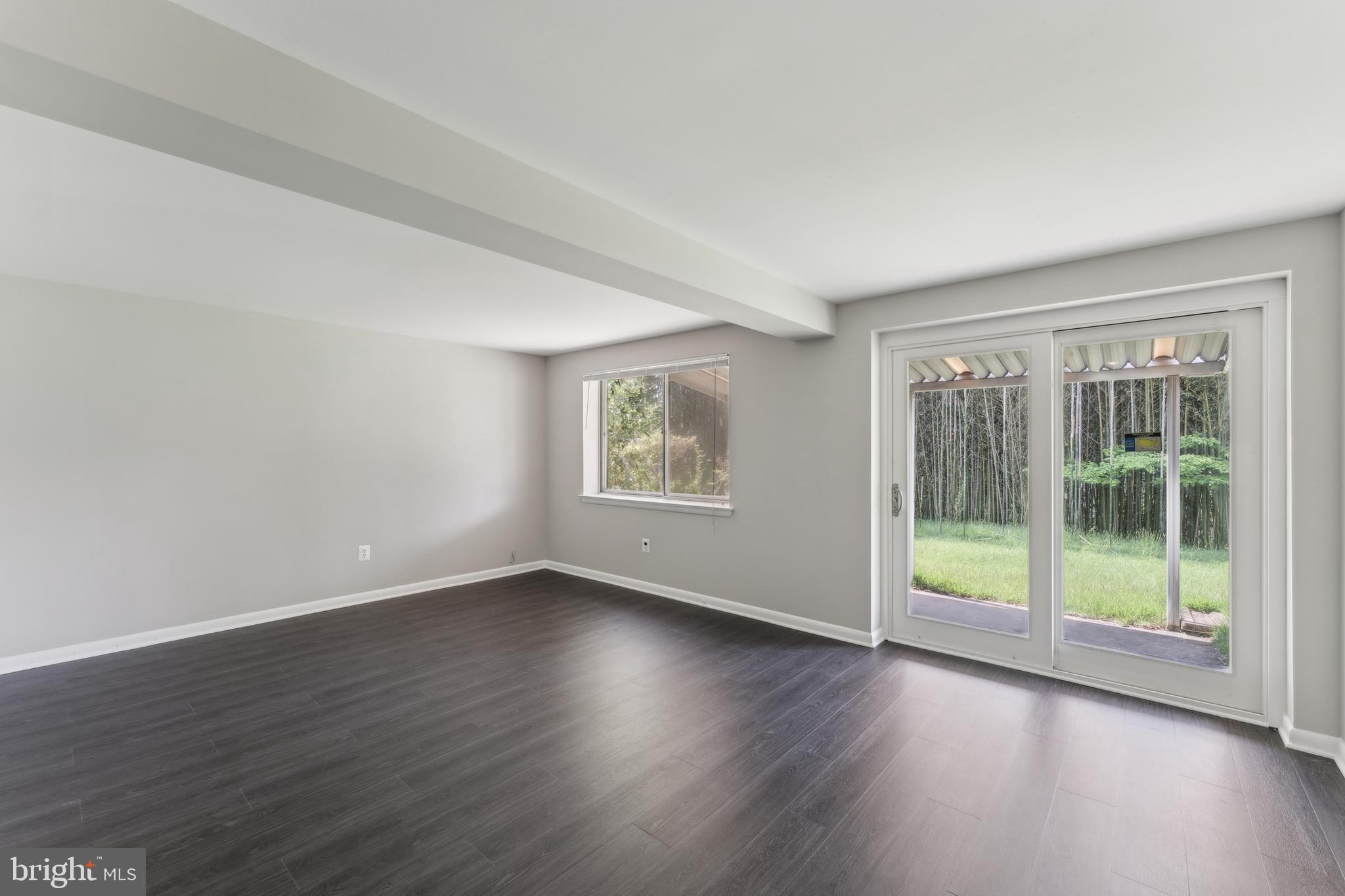 600 Sisson Street Silver Spring, MD 20902 - Photo 21 of 28 a view of an empty room with wooden floor and a window