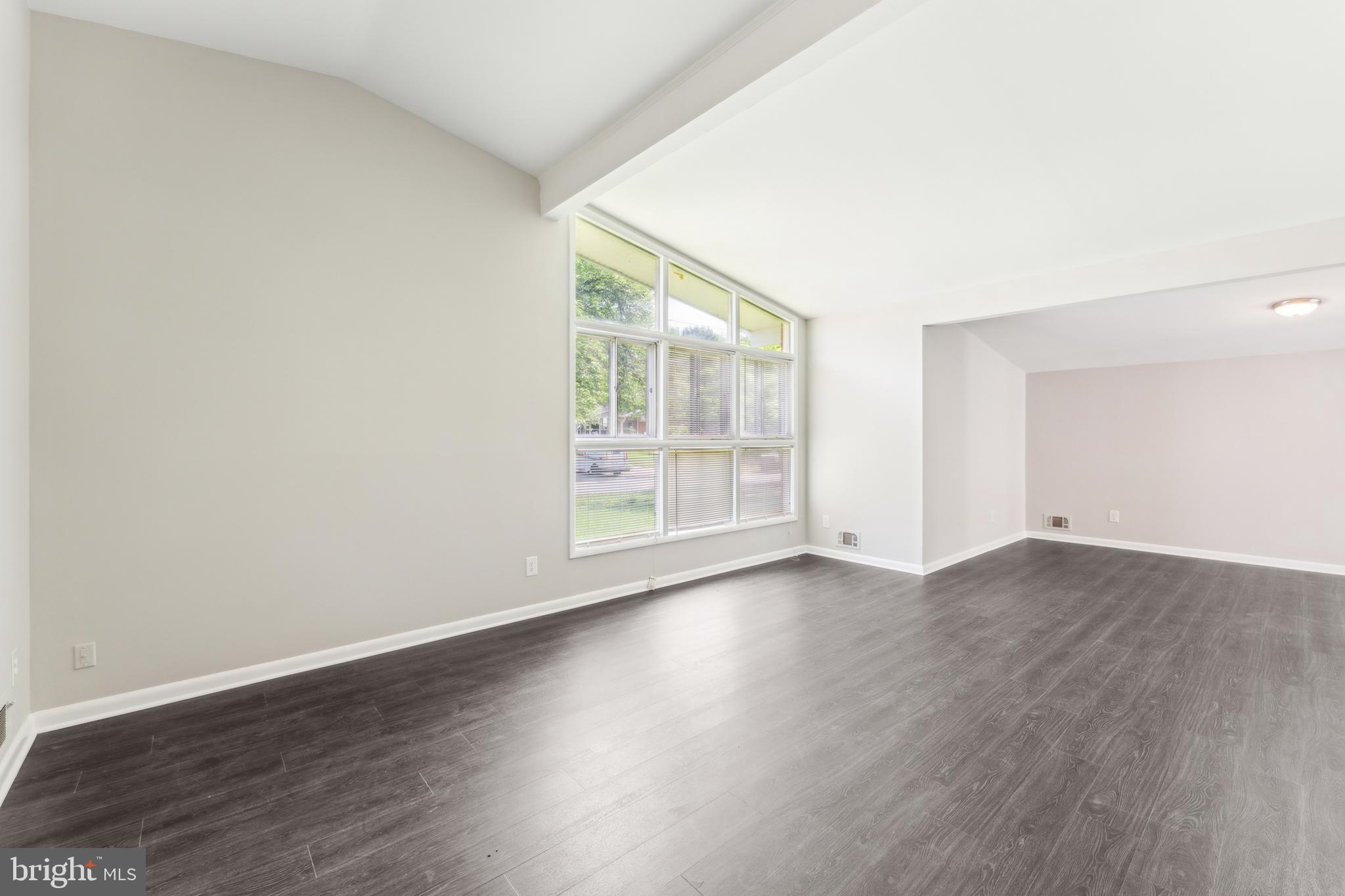 600 Sisson Street Silver Spring, MD 20902 - Photo 4 of 28 an empty room with wooden floor and windows