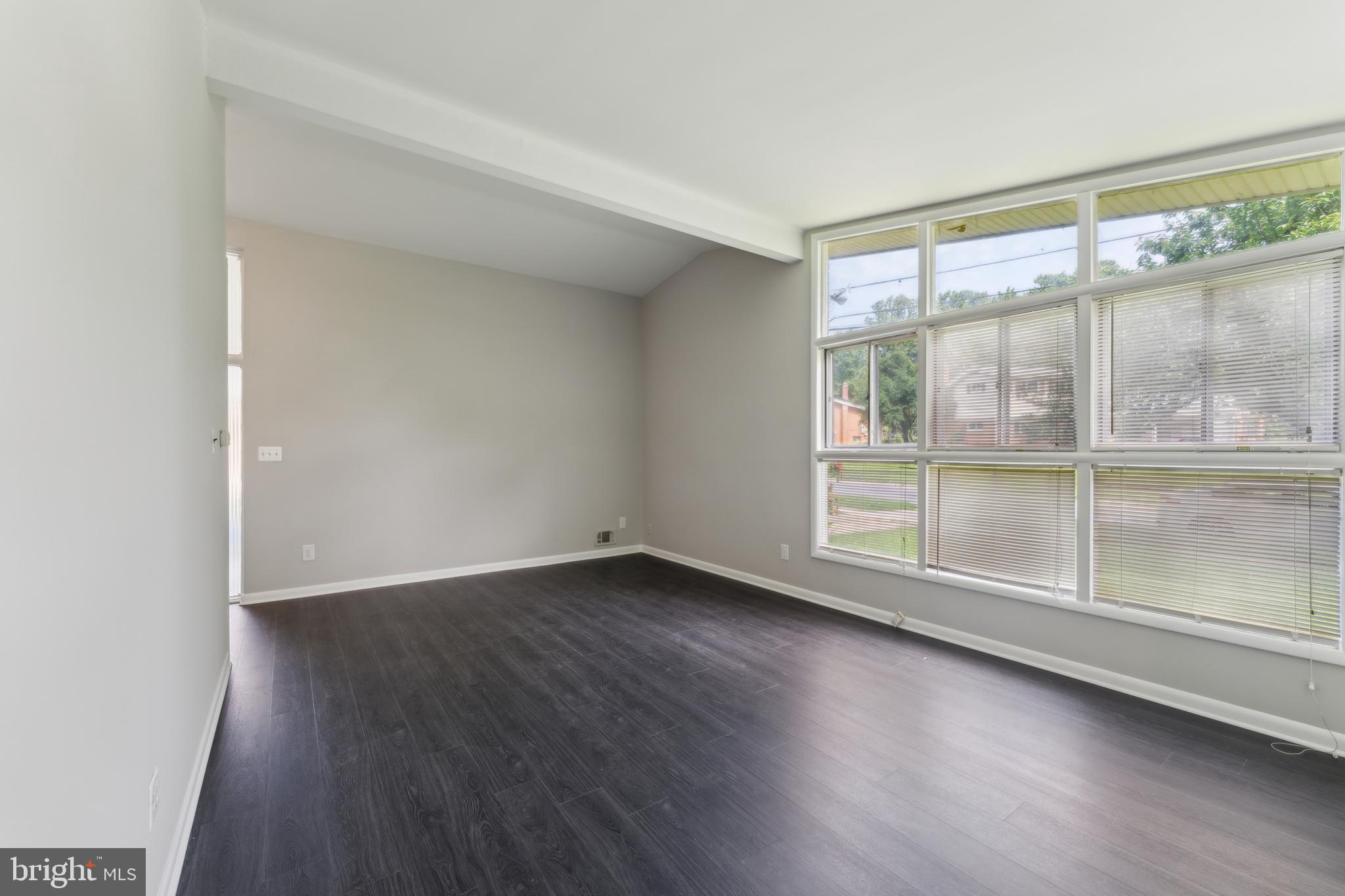 600 Sisson Street Silver Spring, MD 20902 - Photo 7 of 28 an empty room with wooden floor and windows