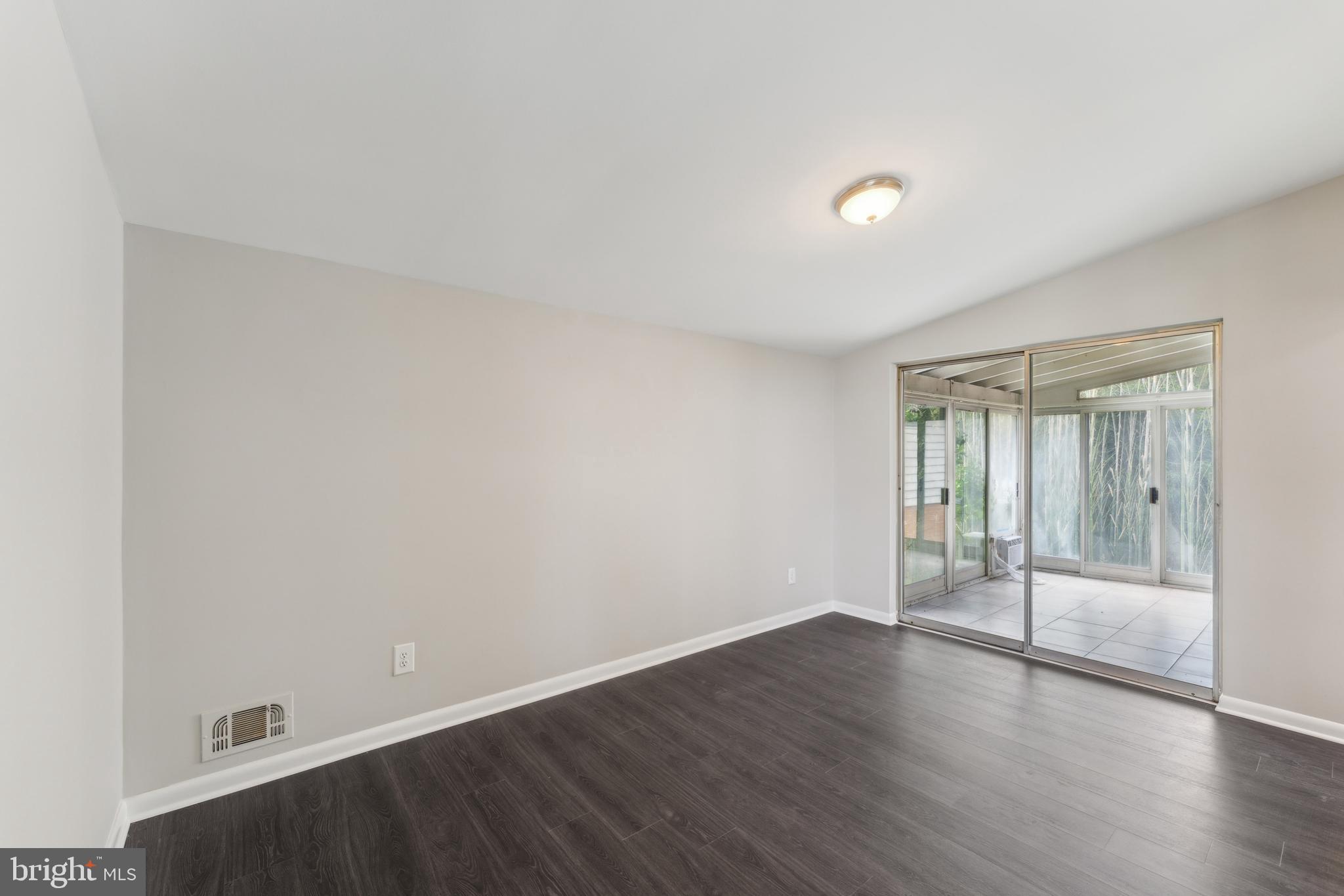 600 Sisson Street Silver Spring, MD 20902 - Photo 8 of 28 a view of an empty room with wooden floor and a window