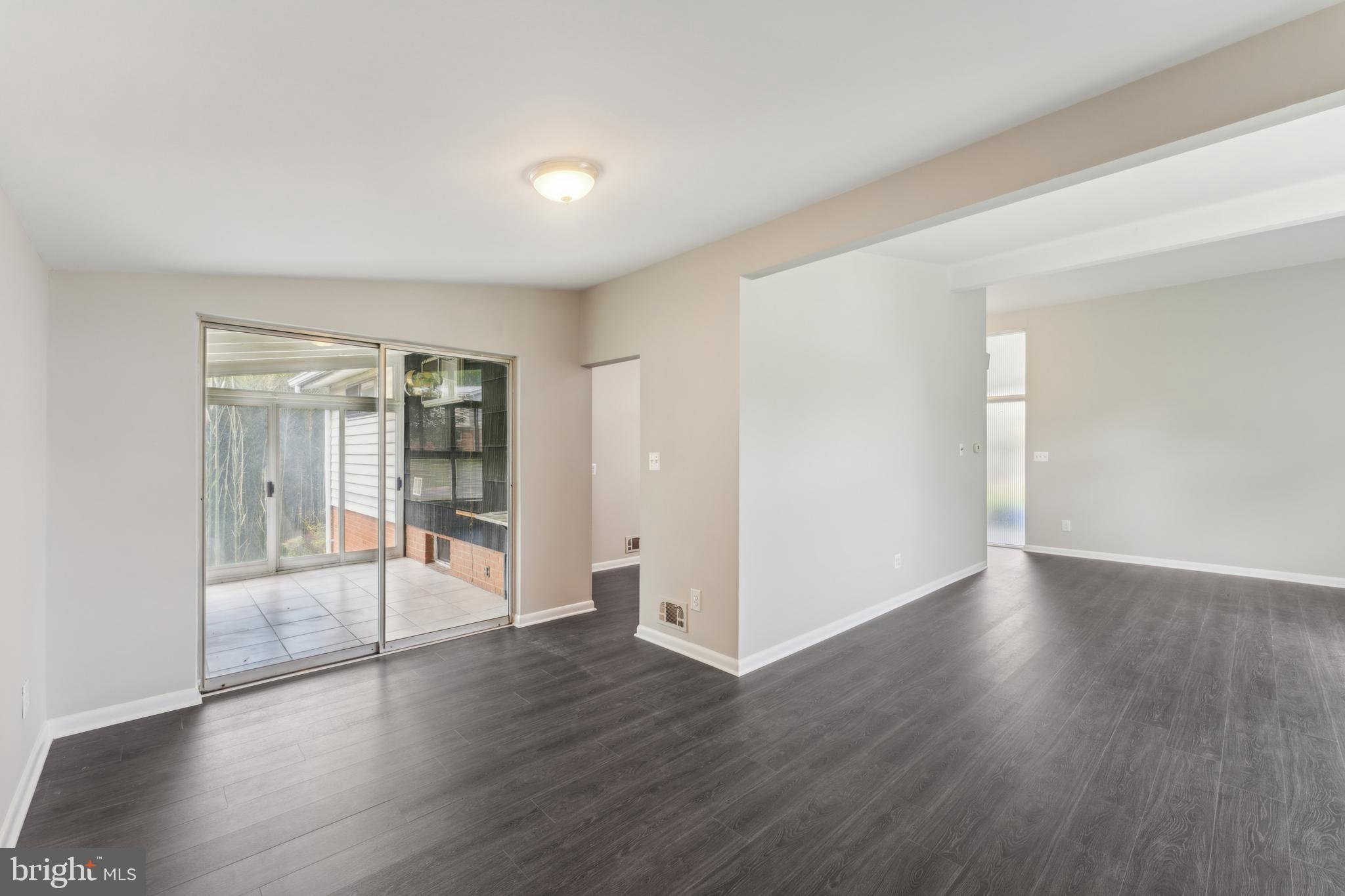 600 Sisson Street Silver Spring, MD 20902 - Photo 9 of 28 an empty room with wooden floor and windows