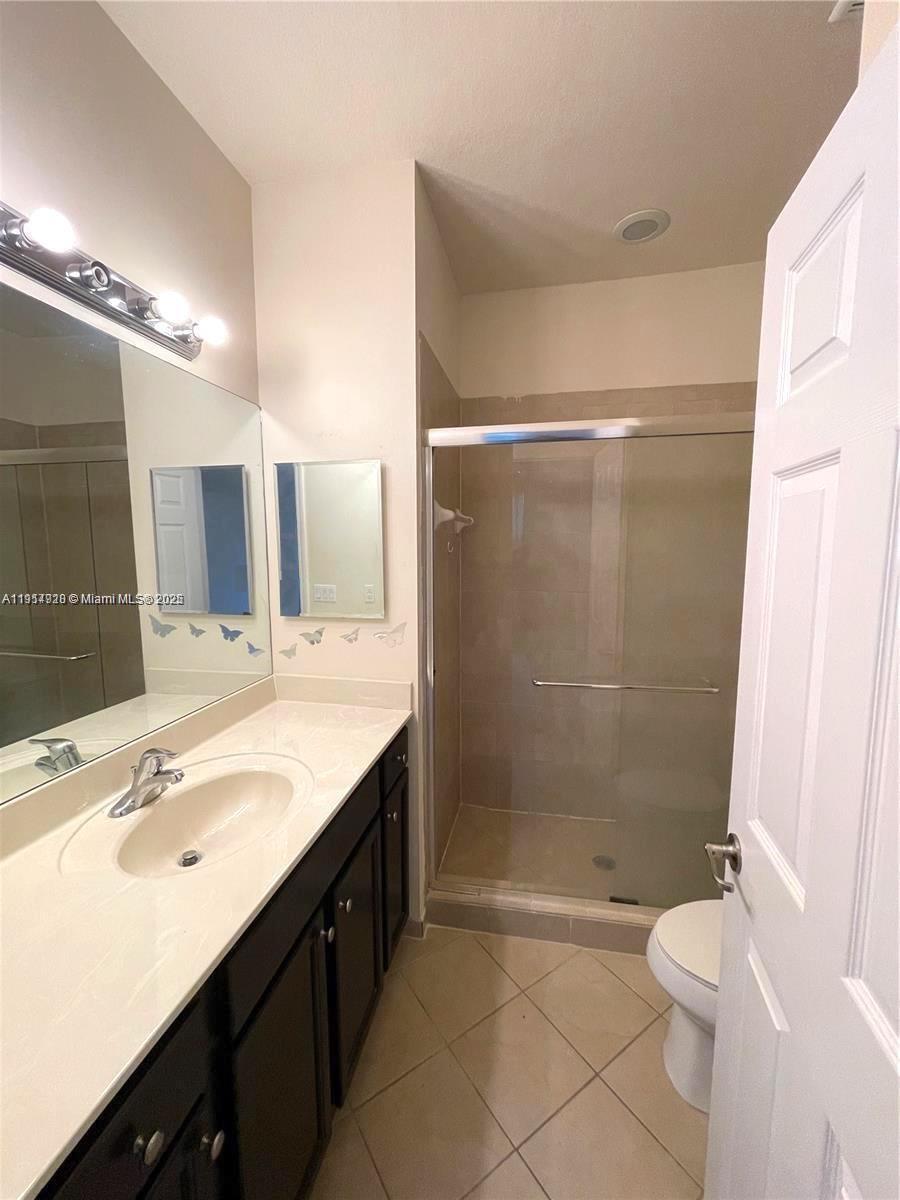 3217 Southeast 4th Street Homestead, FL 33033 - Photo 17 of 20 a bathroom with a double vanity sink mirror and toilet