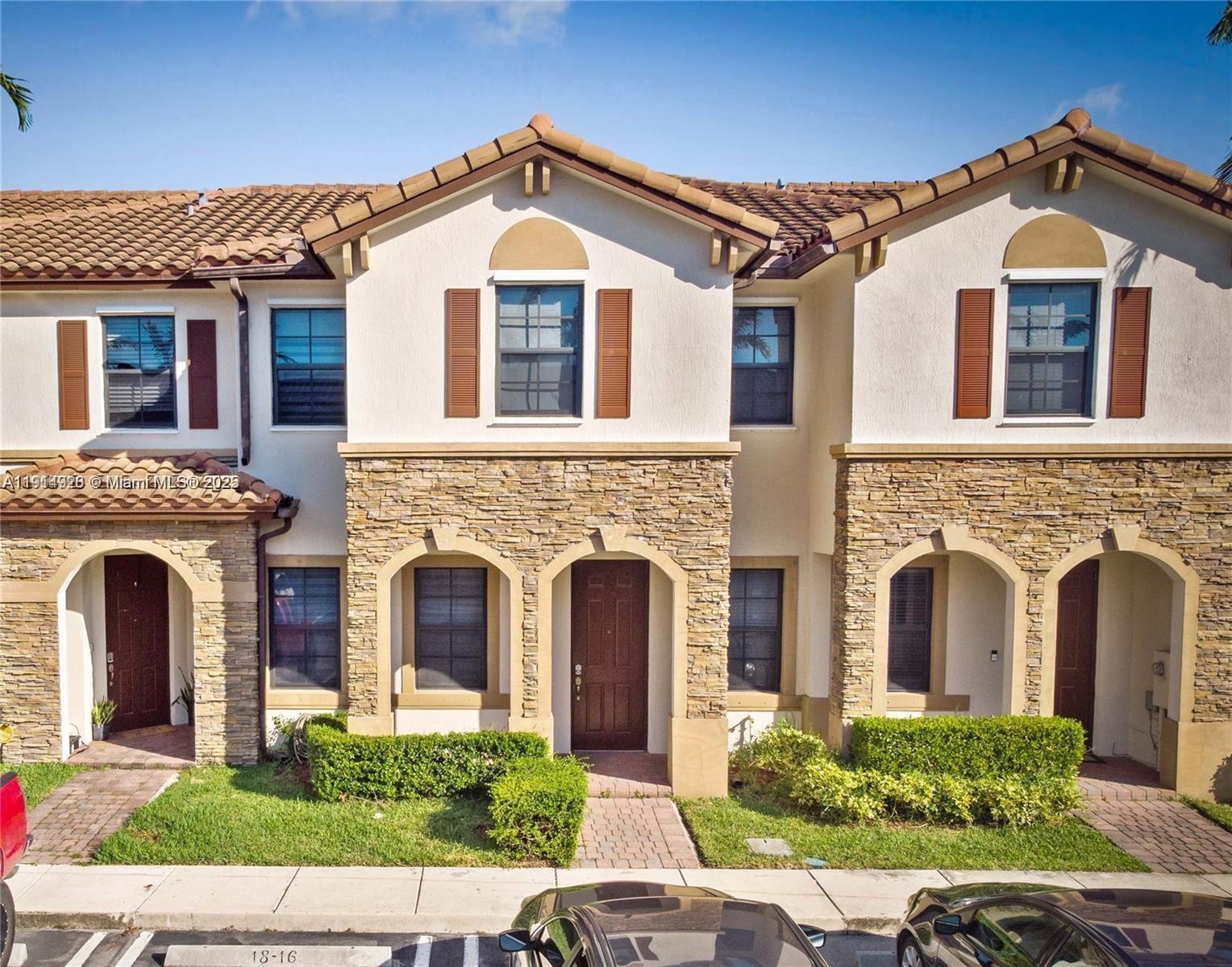 3217 Southeast 4th Street Homestead, FL 33033 - Photo 2 of 20 a front view of a house with a yard and garage