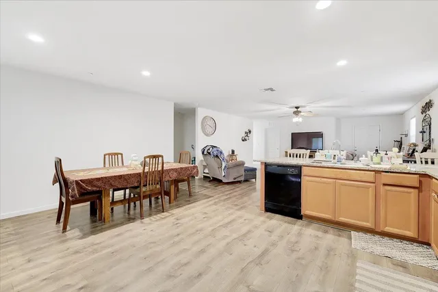 a living room with furniture a dining table and kitchen view