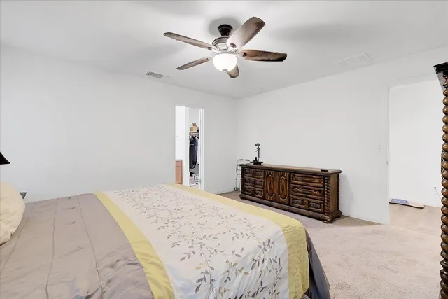 a bedroom with a bed and cabinets