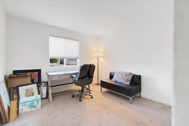 a living room with furniture and a piano