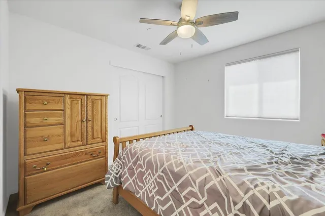 a bedroom with a bed and a dresser