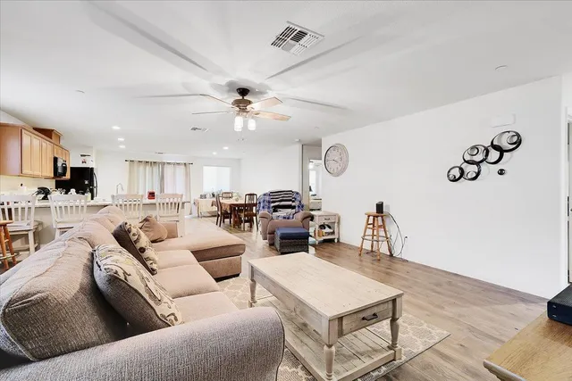 a living room with furniture and kitchen view