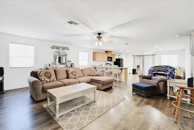 a living room with furniture and a ceiling fan